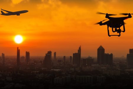 Silhouette of drone flying an airport with airplane, no drone zone concept
