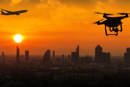 Silhouette of drone flying an airport with airplane, no drone zo Silhouette of drone flying an airport with airplane, no drone zone concept